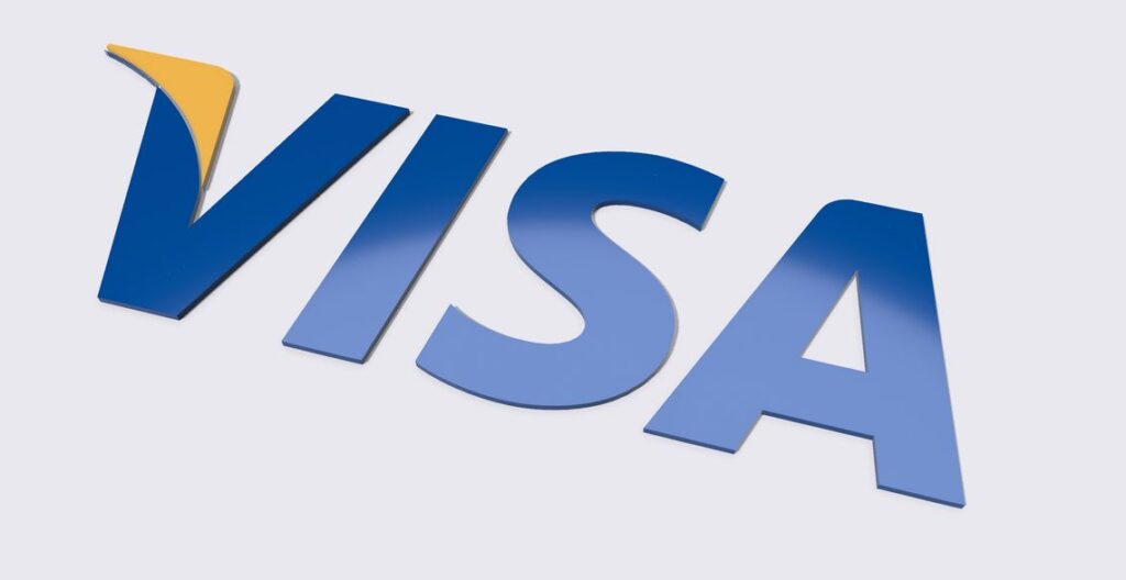 Visa and WhiteBIT shaking hands symbolizing their crypto collaboration