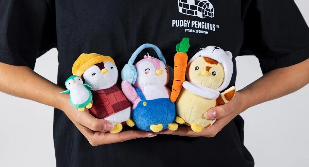 A Pudgy Penguin toy displayed against a Walmart store background.